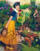 A woman in a yellow skirt holding an apple in a garden.